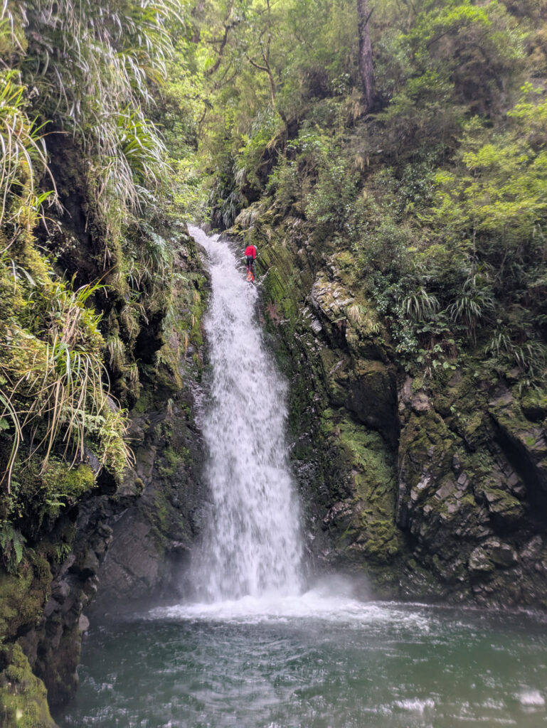 Canyoner descending waterfall